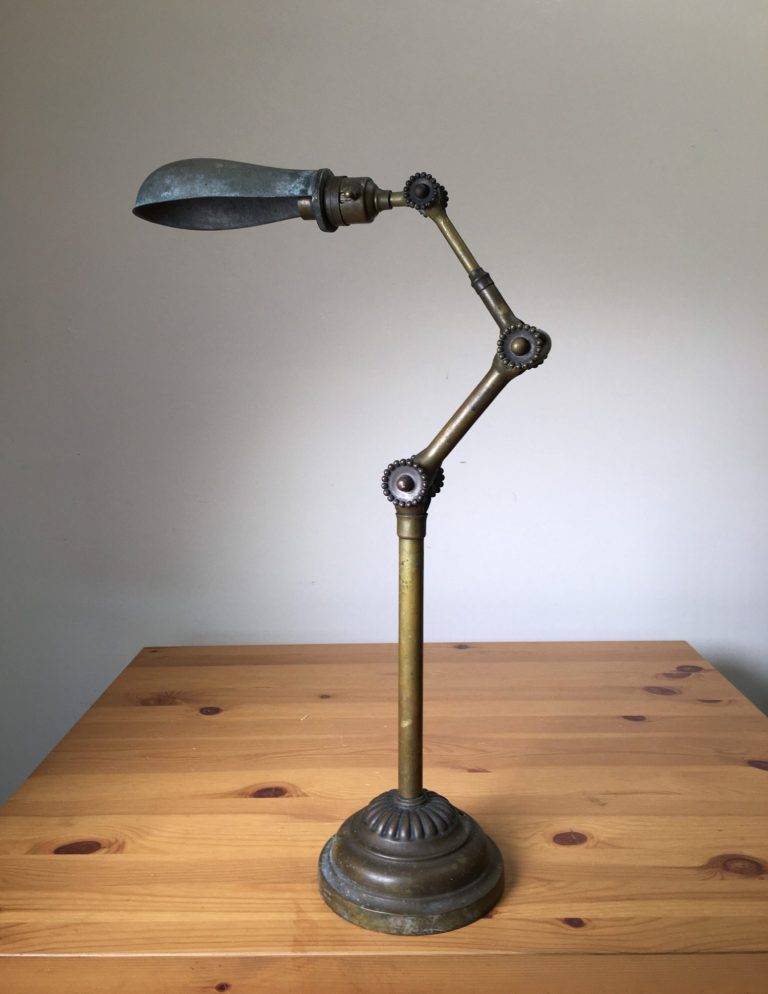 John Dugdill Industrial Task Lamp – UK, ca. 1907 Antique industrial task lamp by John Dugdill with articulated brass arms and cast iron base, UK, ca. 1907